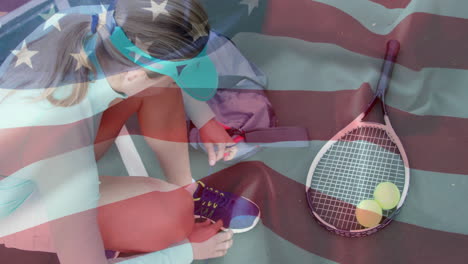 female tennis player kneeling tying laces beside racket balls on court showing sports metrics