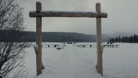 deserted snow covered boat dock over frozen lake in winter