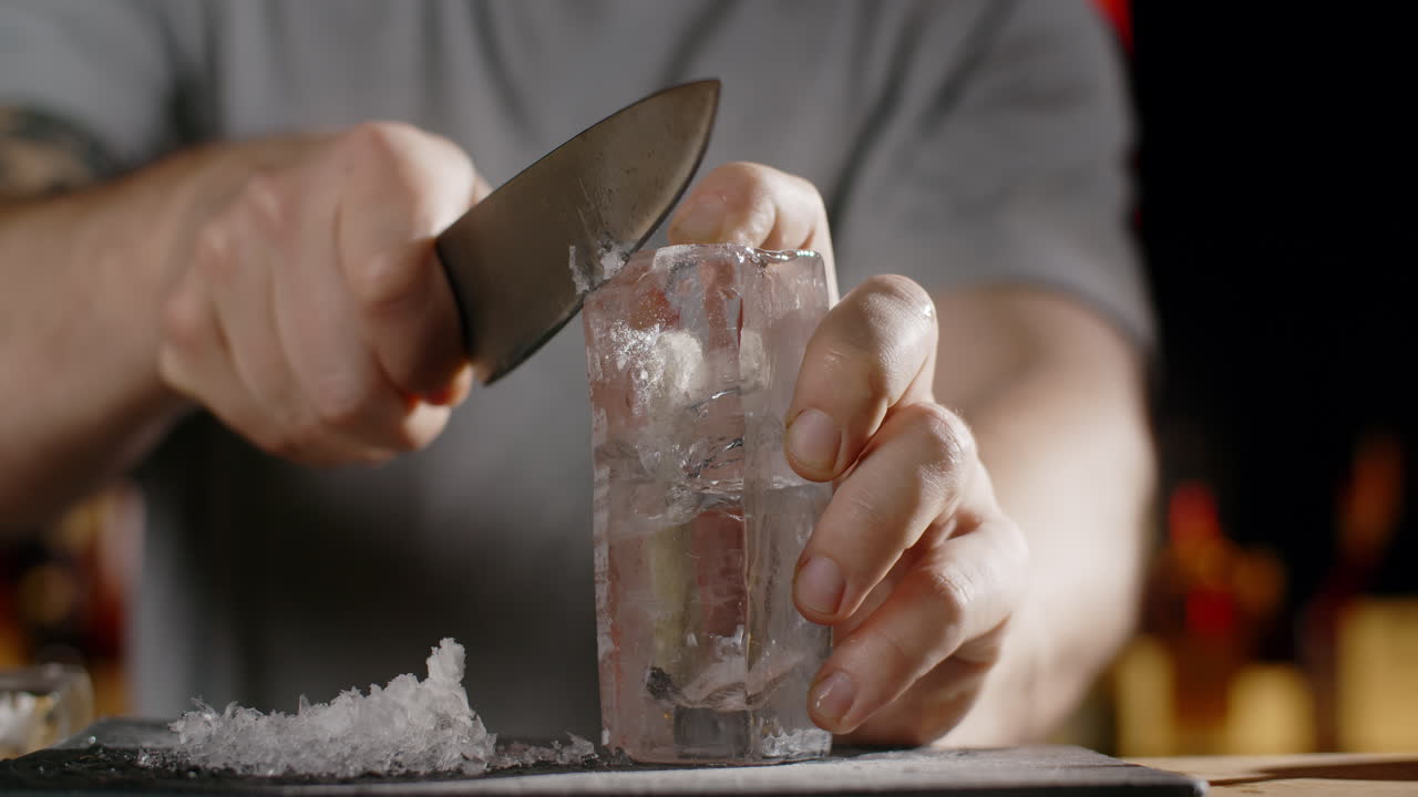 Bartender Cutting Ice for Cocktail