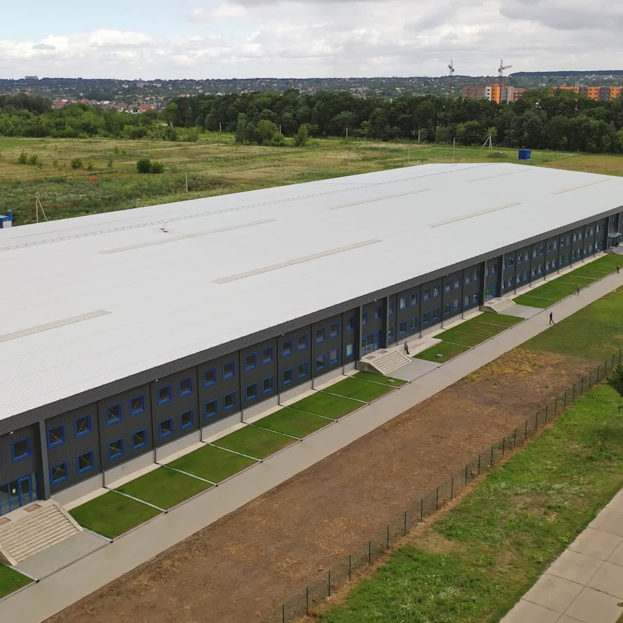 Contemporary industrial factory. Exterior of a large modern production plant in the countryside. Modern production company outdoors. Aerial view.