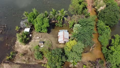 Houses-And-Farm-Field-Surrounded-With-Floodwaters-In-Battambang,-Cambodia---Aerial-Top-View