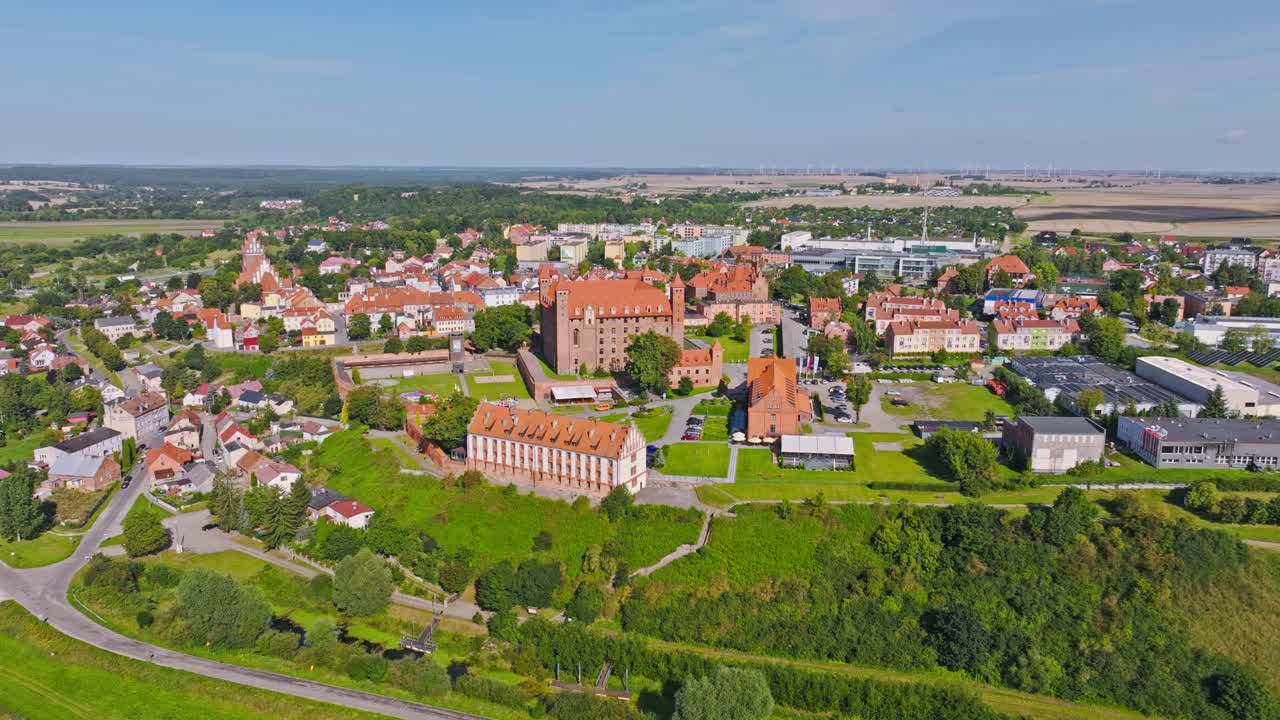 Cinematic drone view of medieval Gniew Castle and surrounding historic old town