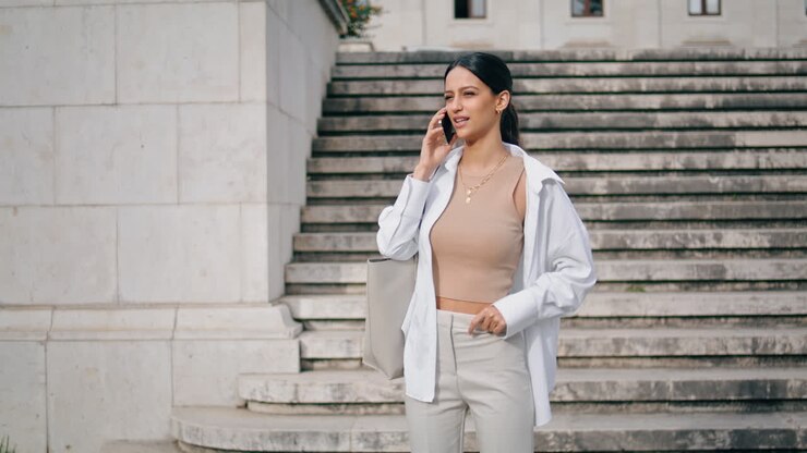 Relaxed businesswoman calling phone staircase vertical. Lady talking telephone