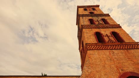 Close-up-low-angle-shot-of-Jesuit-Mission-church-at-sunset,-San-Jose-de-Chiquitos,-Bolivia