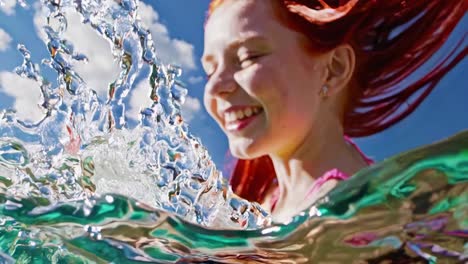 woman playing in water under a cloudy blue sky