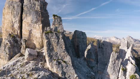 Drone-Flies-Past-Cinque-Torri-Mountains-on-Beautiful-Sunny-Day-in-Italian-Dolomites