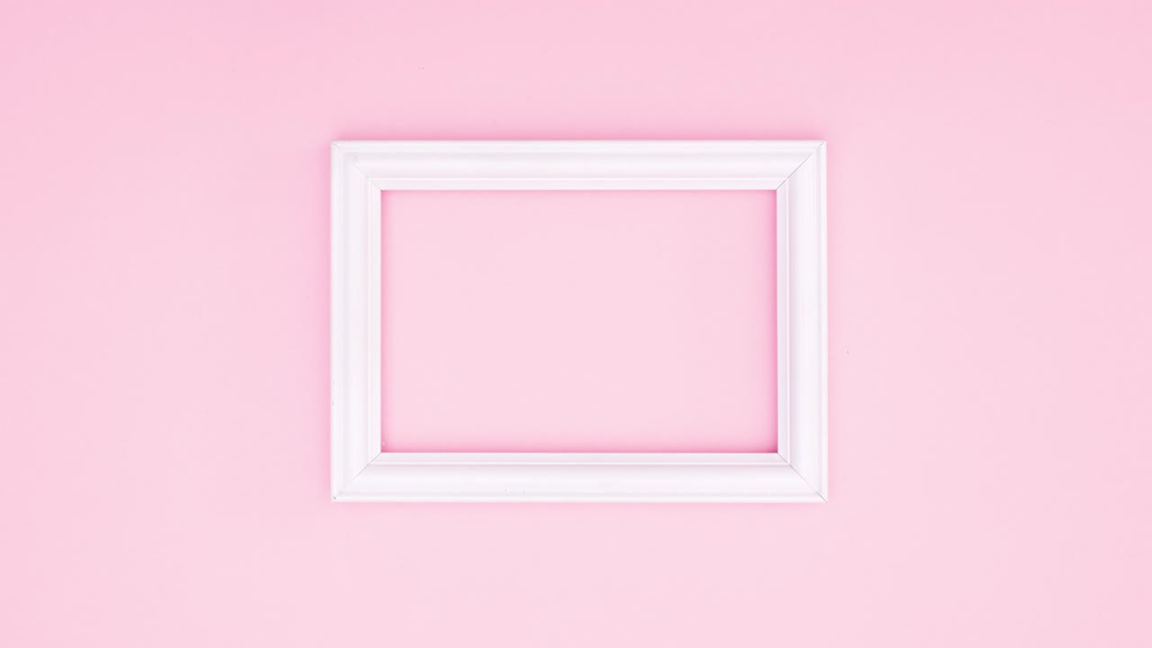 Romantic roses appear and disappear around white frame for text on pink theme. Stop motion
