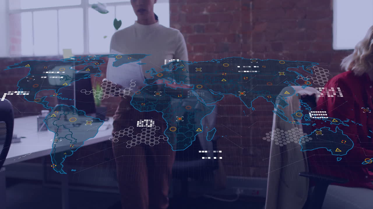 In modern office, animation of world map with data points overlaying workers