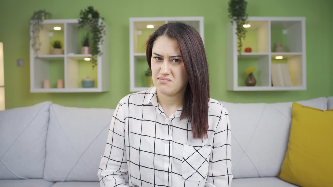 Woman is disgusted, disgusted woman looking at camera.