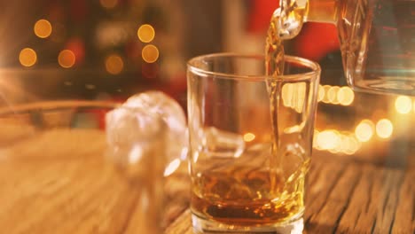 animation of christmas drink being poured into glass with flickering fairy lights