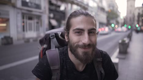 man with backpack in city street