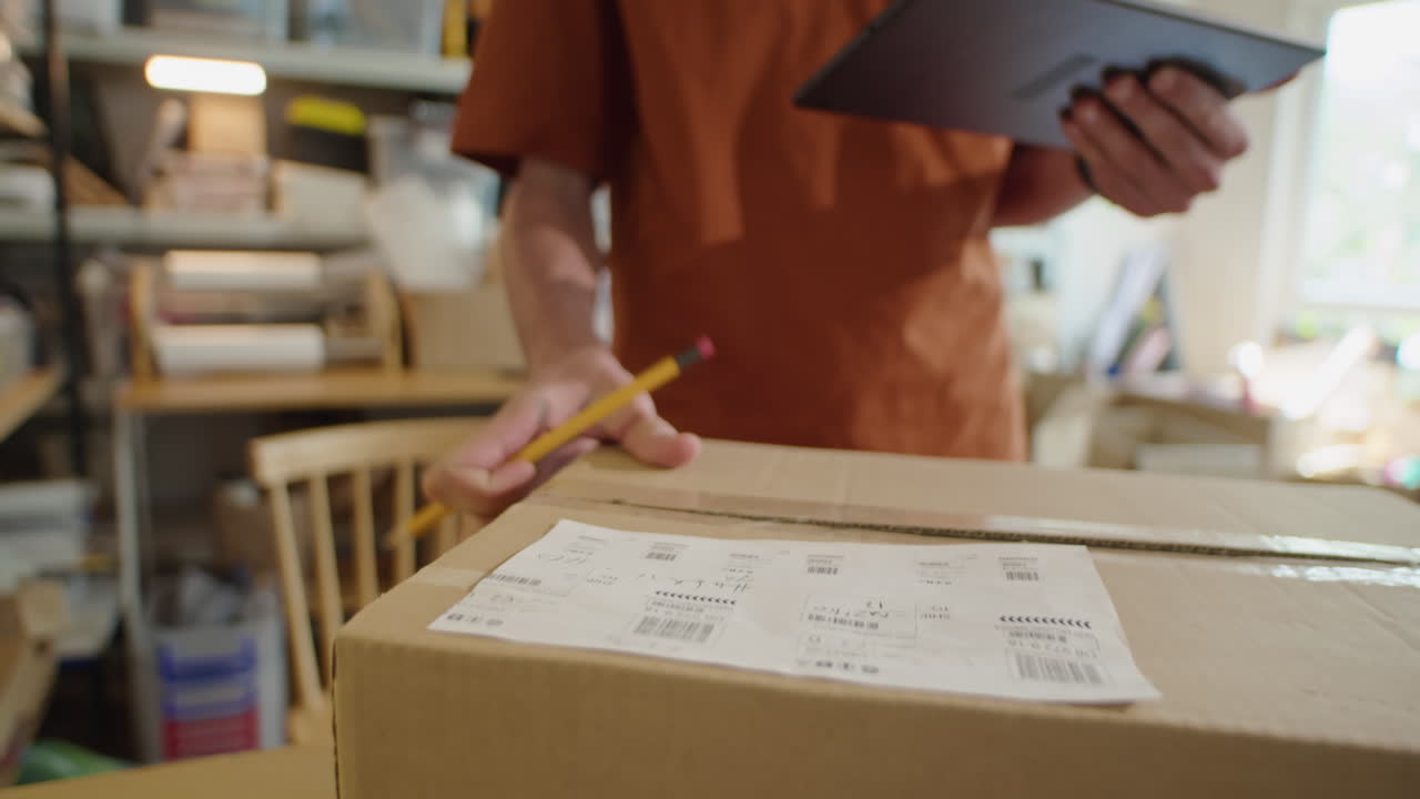 Delivery Service Worker Writing Address on Cardboard Box