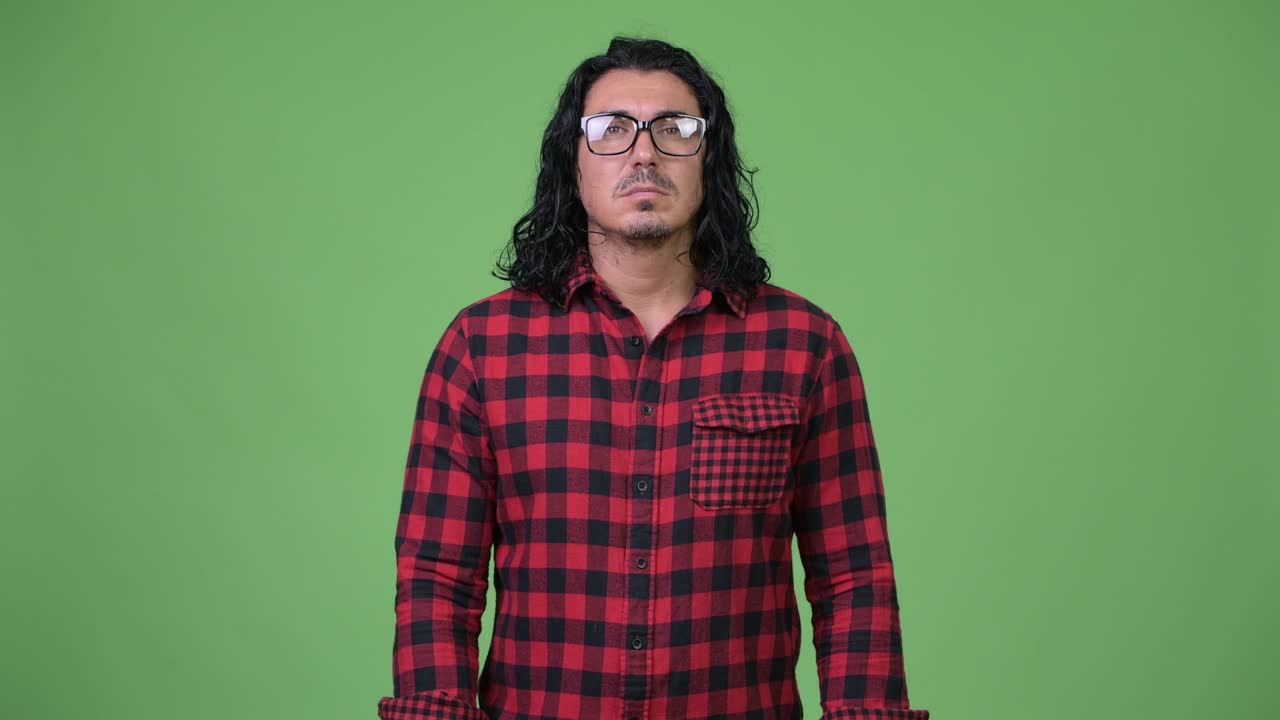 Handsome hipster man smiling while wearing eyeglasses
