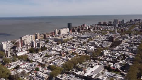 aerial reveal of montevideo city by atlantic ocean coast