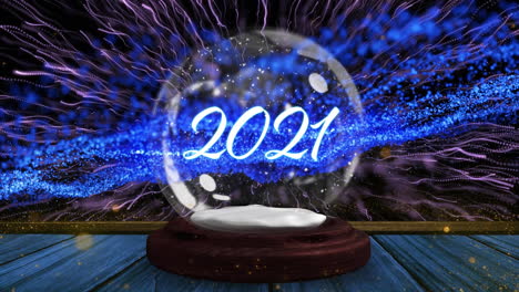 animation of 2021 in snow globe with shooting star and snow falling