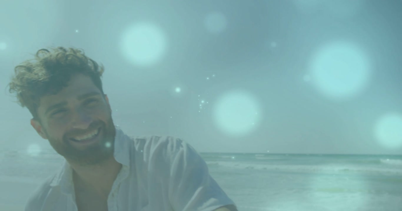 Horizon clearing, woman in wide-brimmed hat smiling, man in open shirt walking to greet at beach