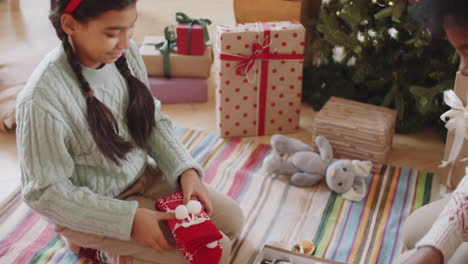 african american mother and daughter preparing christmas presents