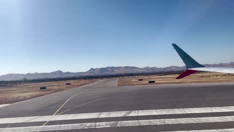 shot of airplane window seat during take off