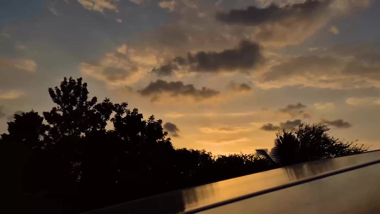 黄金色の夕暮れの光から暗い夜空へと移り変わる劇的な夕焼け雲のタイムラプス。シネマティックなイントロ、背景、雰囲気のある編集に最適です。