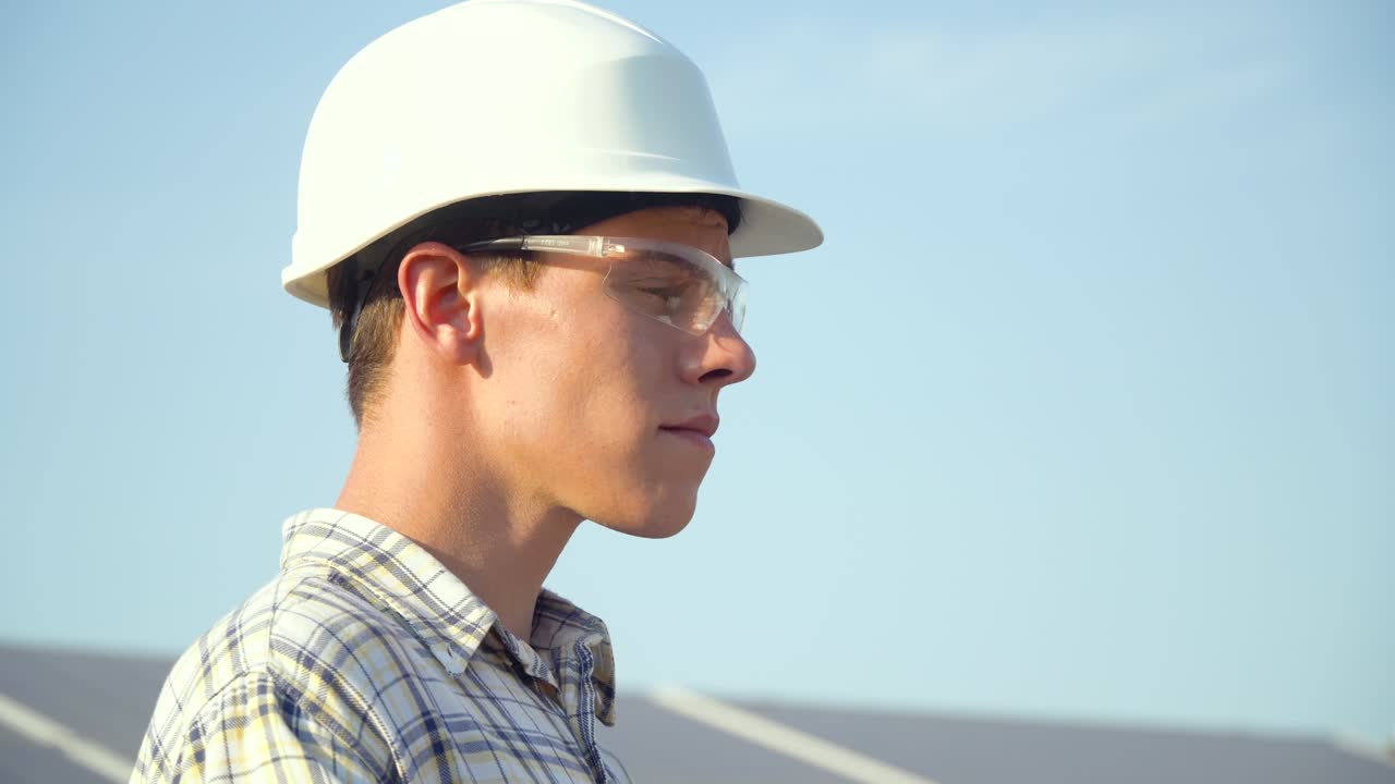 Solar panel technician working with solar panels. Alternative energy concept