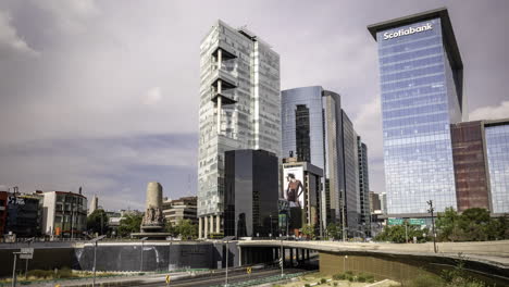 panoramic shot of the petroleos fountain where the busy paseo de la reforma and peripheral avenues converge