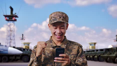 happy soldier using smartphone