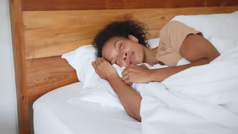 relaxing in bed, woman smiling and enjoying morning at home