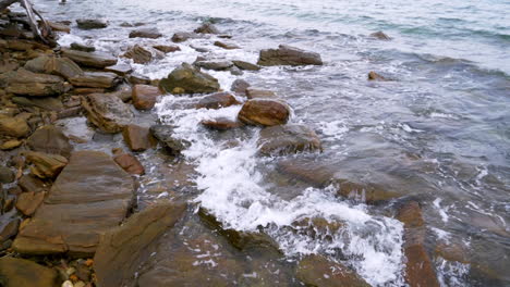 Slow-motion-scenic-landscape-of-nature-sea-wave-coast-to-beach-with-stone-and-rock-for-summer-vacation-concept