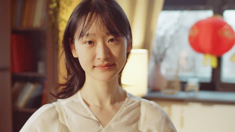 portrait of young asian woman at home