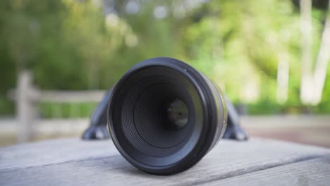 close-up of a camera lens on a wooden table