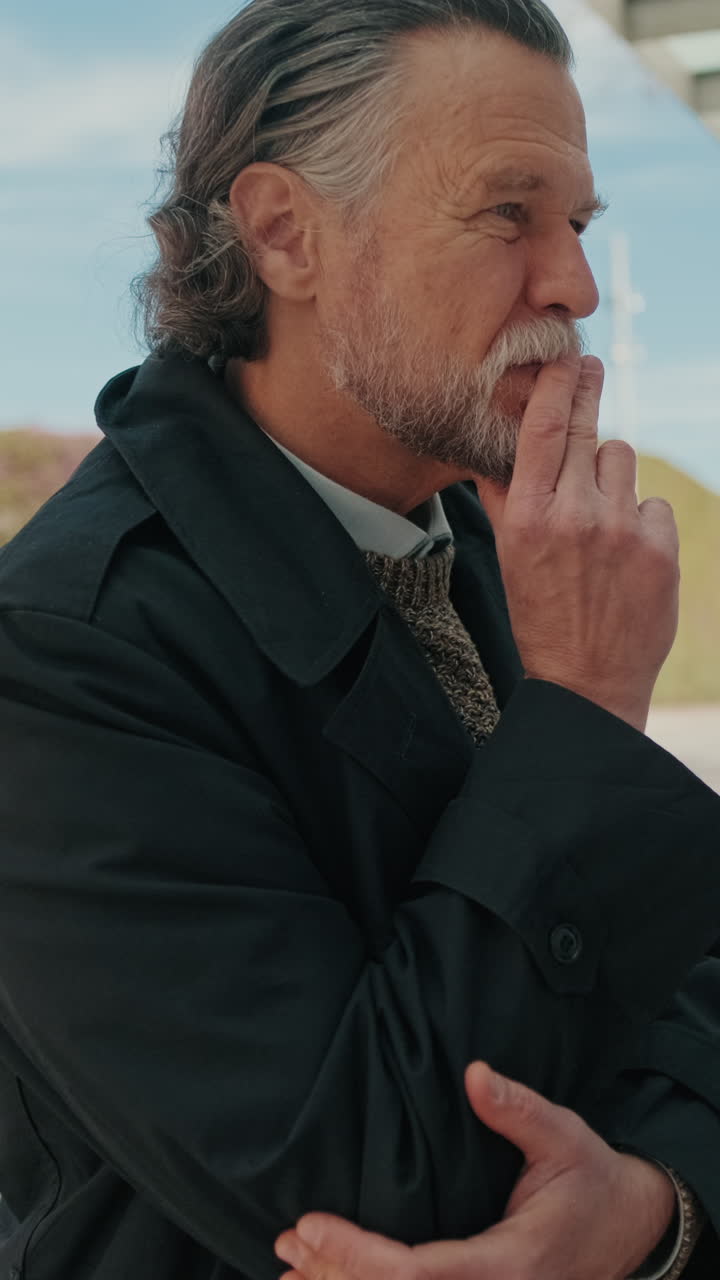 Pensive Businessman Waits at City Bus Stop