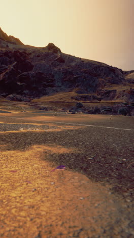 sunset road through a desolate mountain landscape