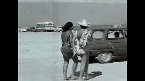 woman resting on sandy beach, enjoying the sun and surf. circa ussr 1970: a woman relaxing on top of a sandy beach, basking in the warmth of the sun and listening to the calming sound of the waves.