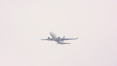 commercial aircraft ascending into thick fog, handheld view