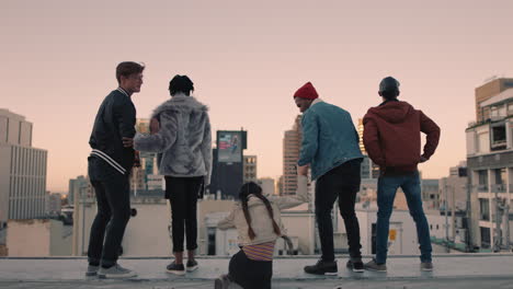 young group of friends on rooftop with arms raised celebrating enjoying hanging out together embracing freedom at sunset