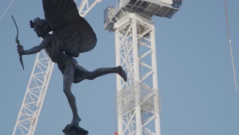 a monument in london with construction work in the backdrop.