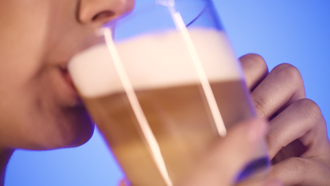 Woman drinks tasty fresh coffee and licks her lips, close-up lips, side profile