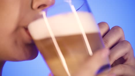 woman drinks tasty fresh coffee and licks her lips, close-up lips, side profile