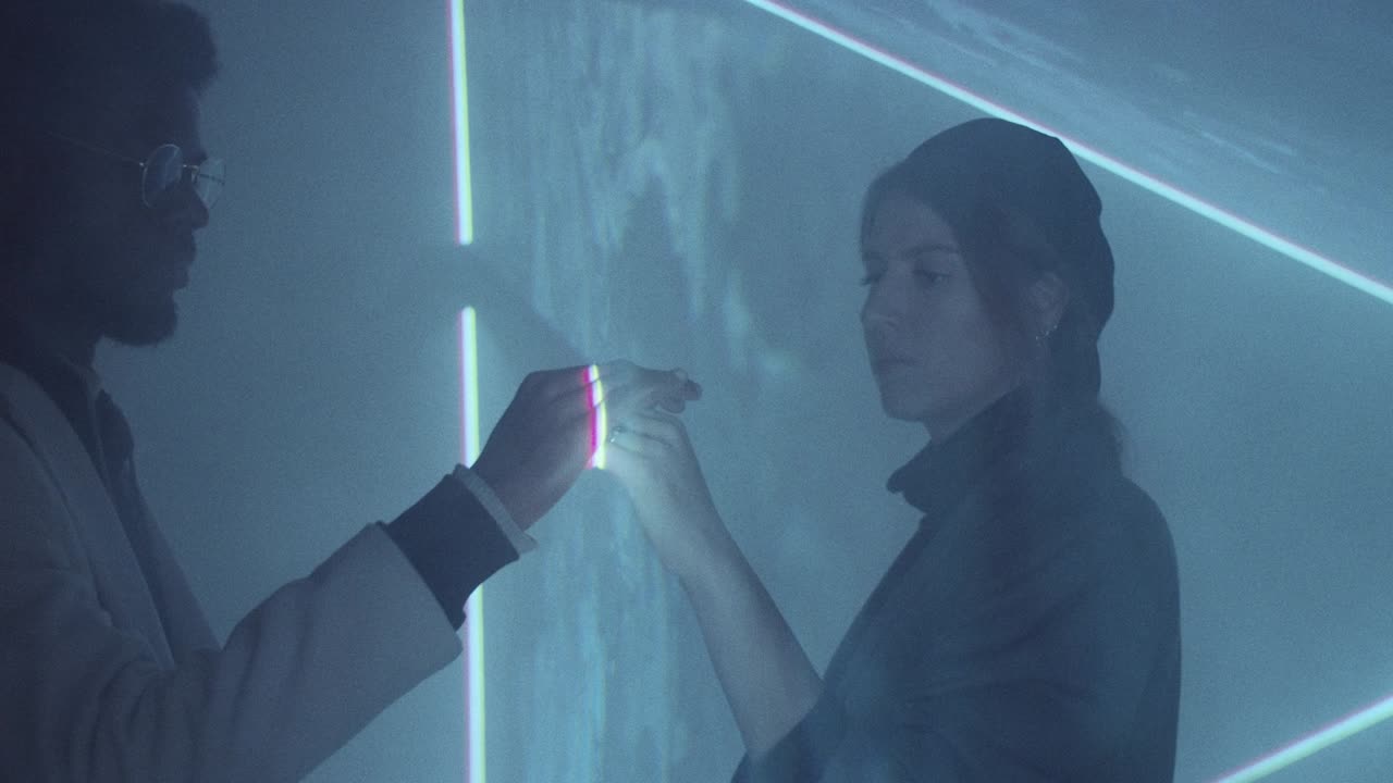 Diverse Man and Woman Touching Hands through Laser Light Sheet