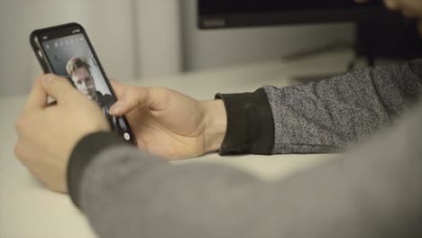 close up of a man scrolling through selfie filters on his phone camera app