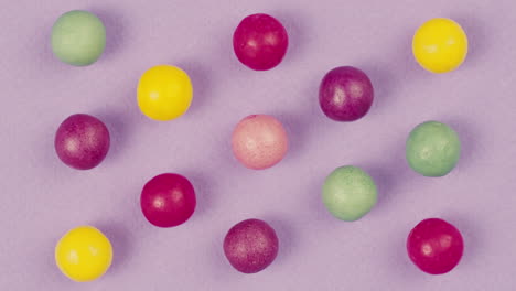 colorful round candies on purple background