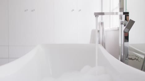 video of close up of running water in bathtub in bathroom