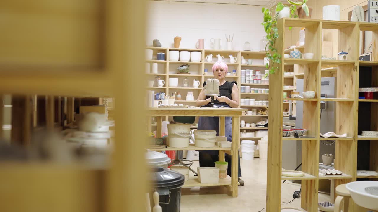 A woman making pottery in a ceramics studio