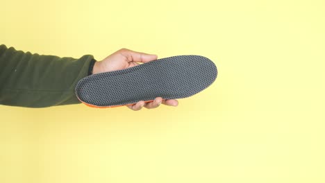 hand holding a shoe insole