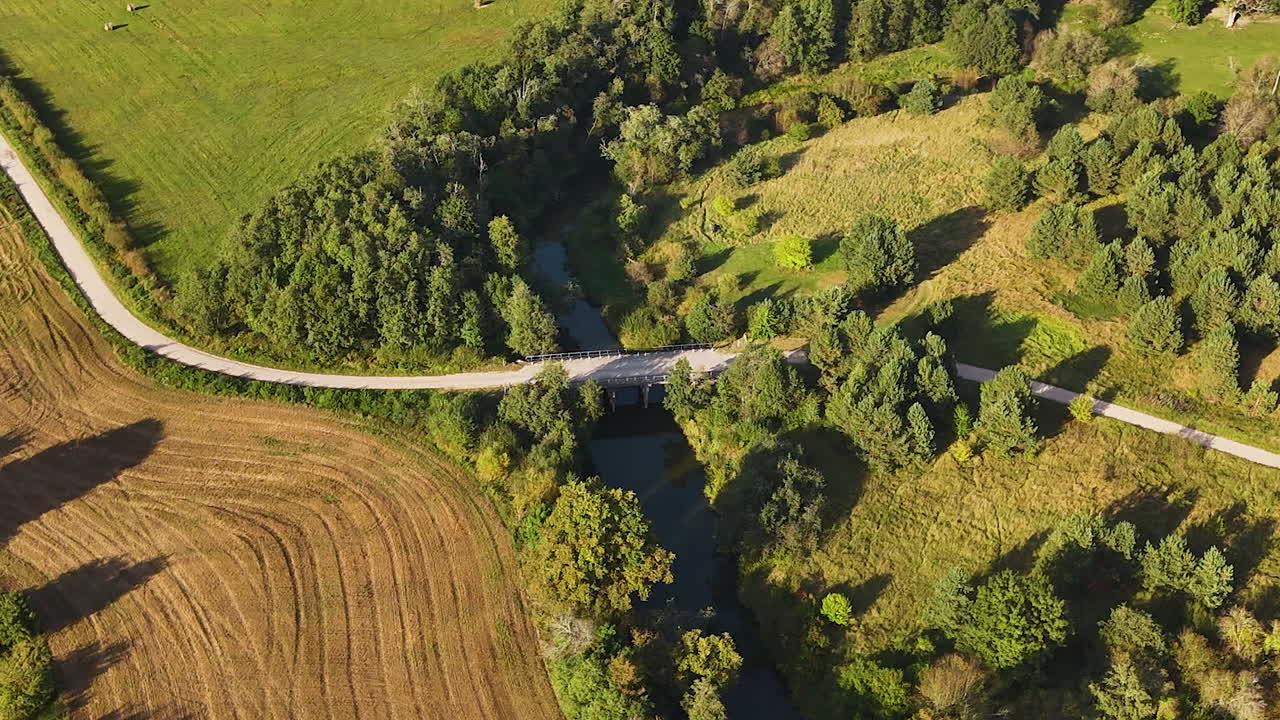 Paved Road With Tebra River In Kurzeme Municipality Of Courland, Latvia. Aerial Drone Shot