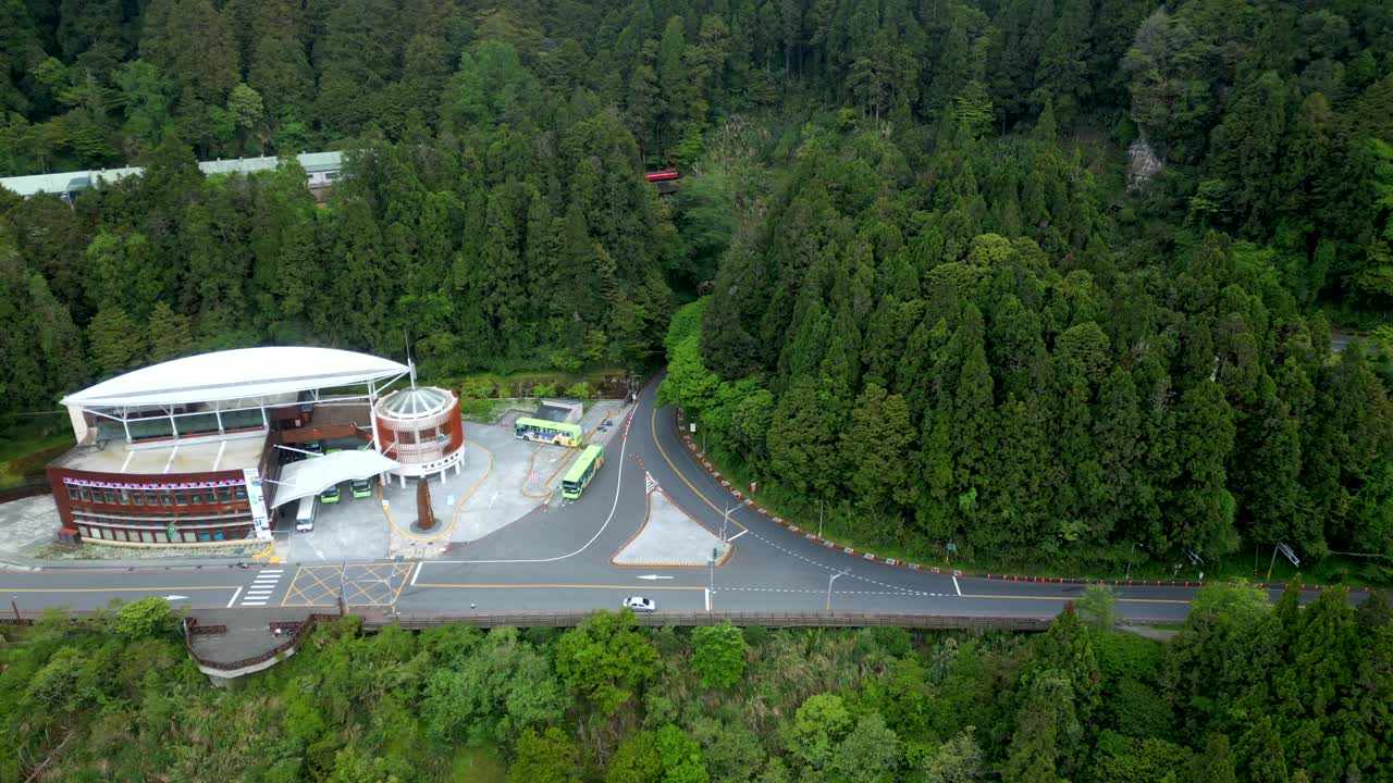 Modern Building At The Entrance Of Alishan National Forest With Vegetation. Alishan Township, Chiayi, Taiwan. aerial sideways shot