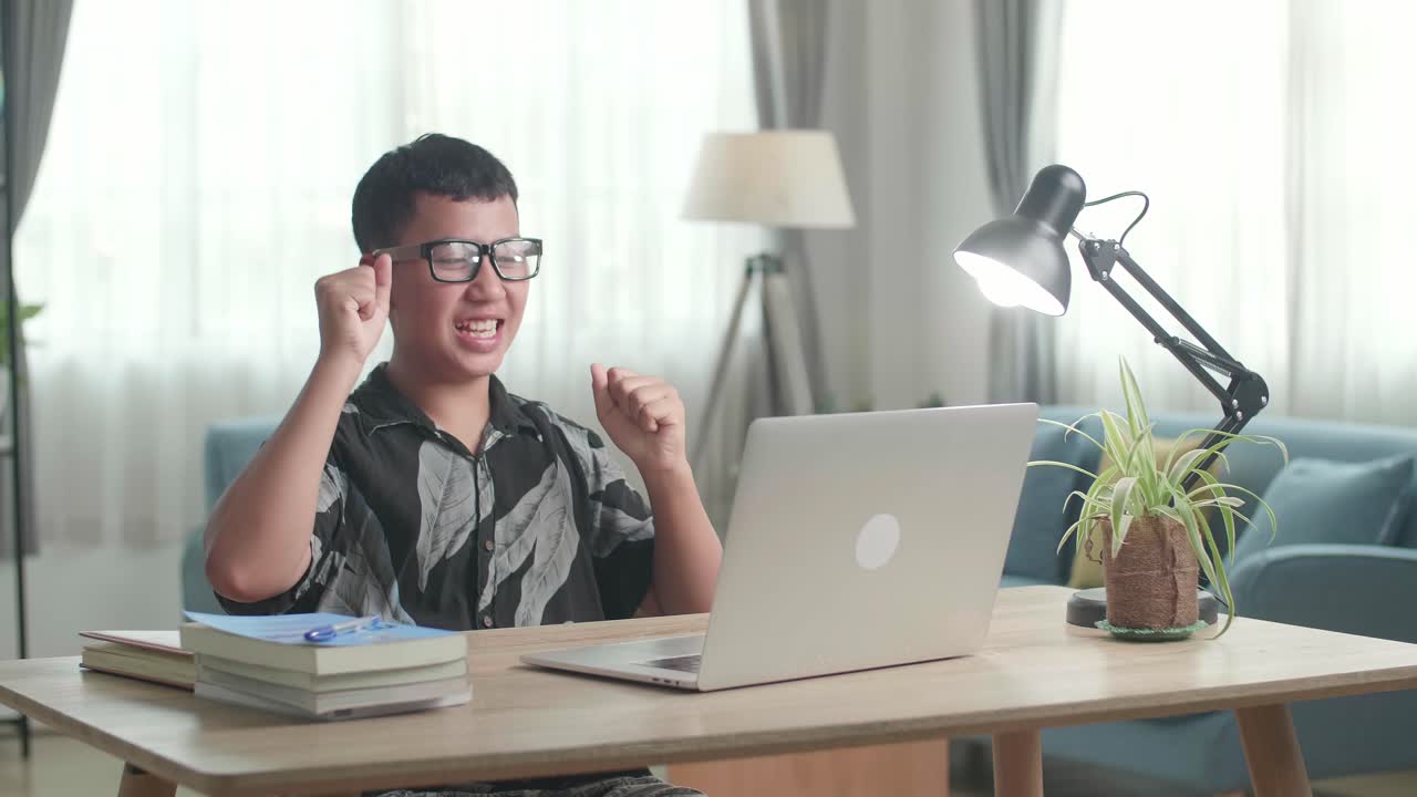 Young Asia Boy Student Celebrating With Laptop Computer At Home, Teenage Boy Learning Online From Laptop
