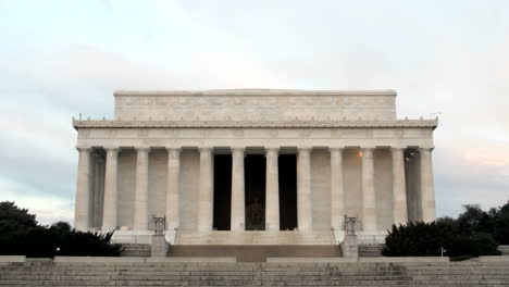 pedestrians and tourists walk around and through the lincoln memorial in washington dc