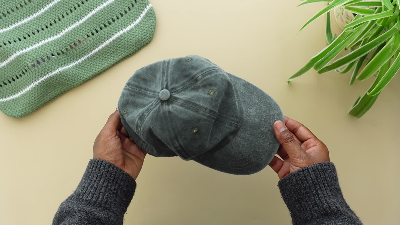 Overhead shot of hands holding a baseball cap