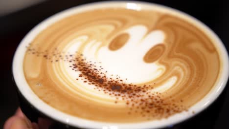 a delightful coffee art experience featuring a playful latte design with creamy foam, chocolate dust, and an inviting smile in every sip